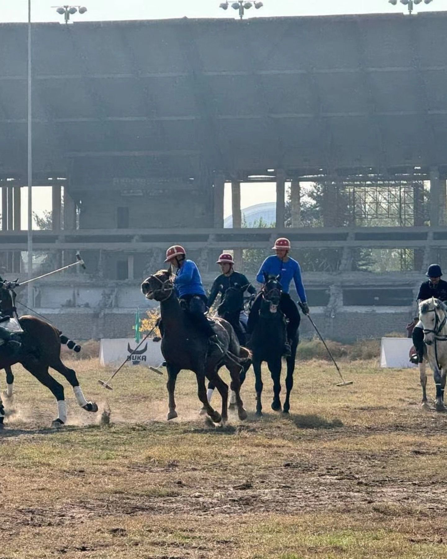 Quyosh botayotganda ippodrom tribunasi oldida polo oʻyini